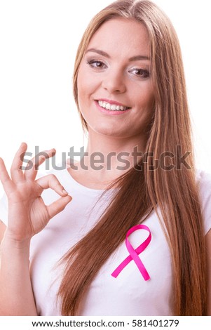 Healthcare, medicine and breast cancer awareness concept. Content young woman with pink cancer ribbon on chest making ok hand sign gesture, isolated on white