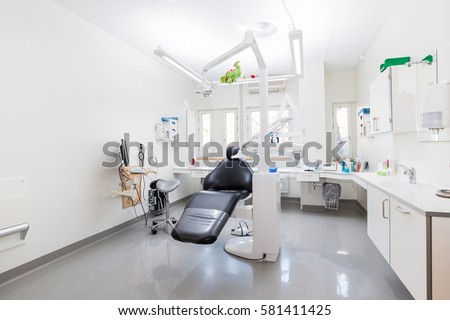 Modern dental practice. Dental chair and other accessories used by dentists. Royalty-Free Stock Photo #581411425