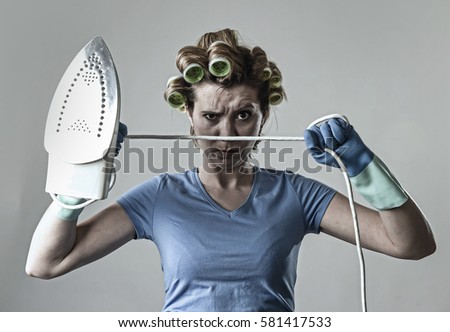 young attractive woman or housewife sad bored and stressed holding iron angry and frustrated in domestic work housekeeping and housework concept isolated background