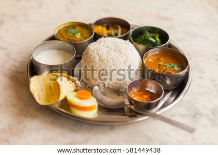 Vegetarian Nepali Thali (Dal Bhat) set, a traditional meal with rice and pulses in Nepal Royalty-Free Stock Photo #581449438