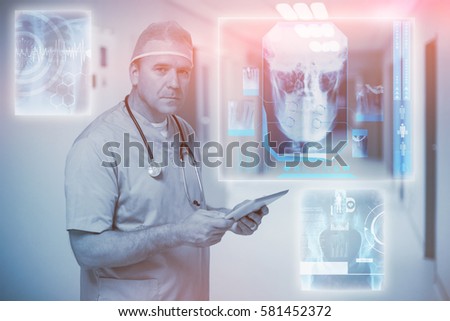 Digitally generated image of human skull against male surgeon holding digital tablet 3d