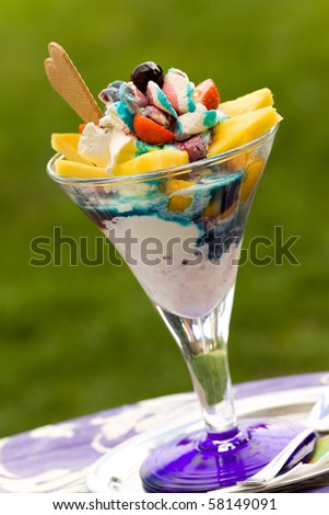 Ice cream in glass bowl on green background