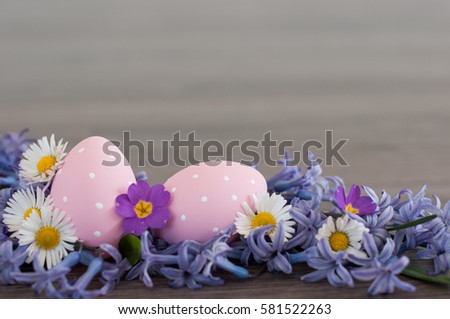 Two pink Easter eggs with spring flowers