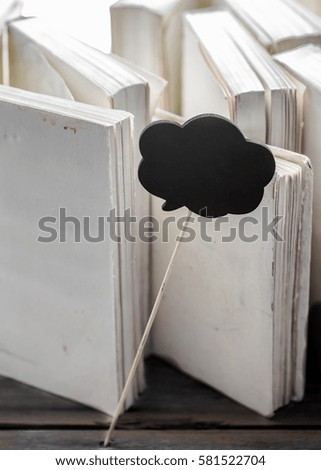 white paper on wood background with space for text, concept of knowledge and information