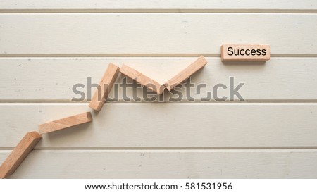 graph wood block and success word written on wood block