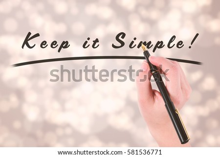 Businesswomans hand writing with fountain pen against light glowing dots design pattern