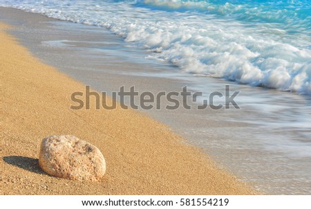 Soft golden greece beach with wave in the background 