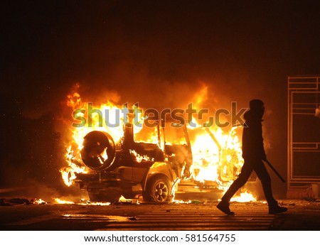 burning car, unrest, anti-government, crime Royalty-Free Stock Photo #581564755