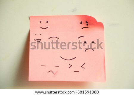 Pink sticky paper note emotion face.