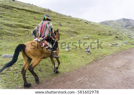 A native with his mule in front of the mountains