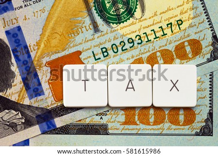 Tax concept - letter tag on money background