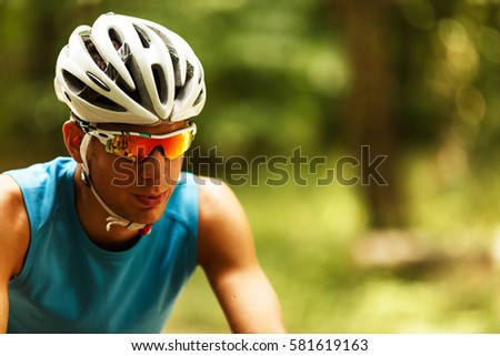 Portrait of mountain biker with helmet and sunglasses.