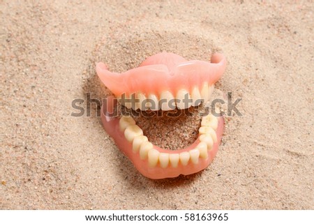 Denture bites the sand