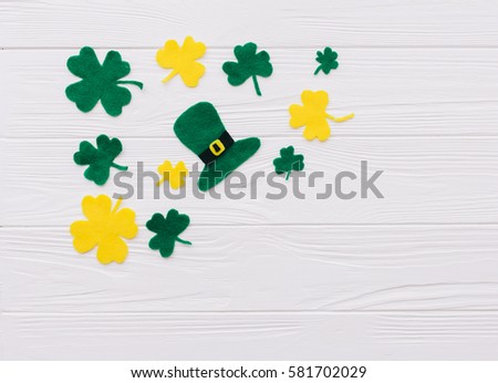 Traditional Irish St. Patrick's Day symbols hat, beer,clover leafs and coins on wooden background