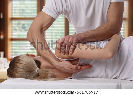 Woman having chiropractic back adjustment. Osteopathy, Alternative medicine, pain relief concept. Physiotherapy, sport injury rehabilitation Royalty-Free Stock Photo #581705917