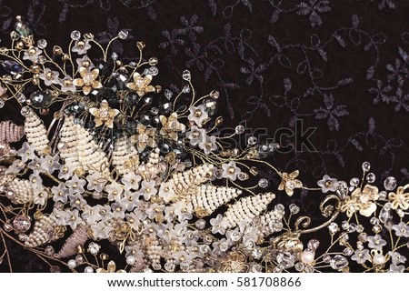 Beautiful elegant background with vintage jewelry comb hair accessories for brides and gold twigs with beads. Royalty-Free Stock Photo #581708866