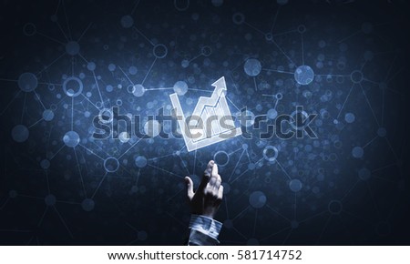 Close of businessman hand pointing with finger at graph icon on dark background