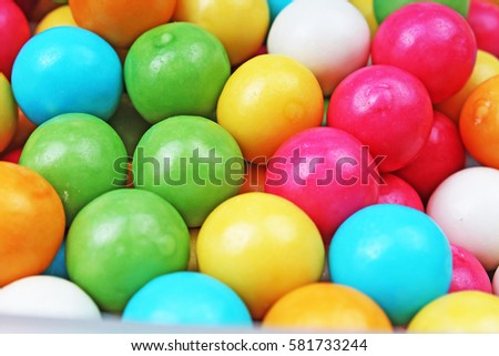Bubble gum chewing gum texture. Rainbow multicolored gumballs chewing gums as background. Round sugar coated candy bubblegum texture. Food photography. Colorful bubblegums wallpaper.
