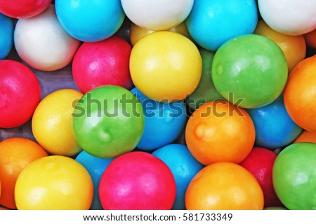 Bubble gum chewing gum texture. Rainbow multicolored gumballs chewing gums as background. Round sugar coated candy bubblegum texture. Food photography. Colorful bubblegums wallpaper.
