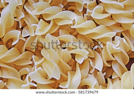 Fusilli dry pasta background concept. Pasta texture for background uses. Swirled pasta pattern. Food photography in studio.
