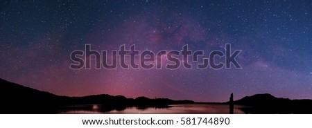 Beautiful panorama shot of Milky way. Raise above the lake in thailand.