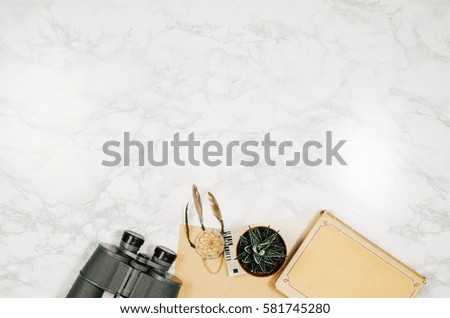 Accessories for travel top view on white natural marble background with copy space. Adventure and wanderlust concept image with accessories. Traveler preparing for an exotic trip and journey.