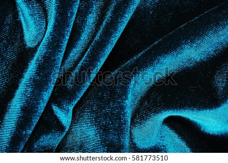 Velvet dress material cloth texture pattern. 
tailoring stitching concept. Velvet cloth. Shiny beautiful fashion fabric. Shiny clothing material sample.Creased fabric.
Blue Velvet material.