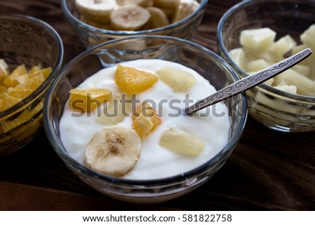 the yogurt with fruits orange banana pineapple apple Royalty-Free Stock Photo #581822758