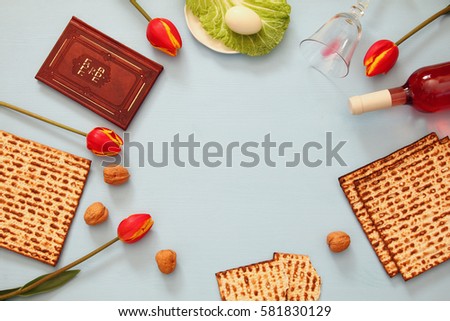 Pesah celebration concept (jewish Passover holiday). Traditional book with text in hebrew: Passover Haggadah (Passover Tale) Royalty-Free Stock Photo #581830129