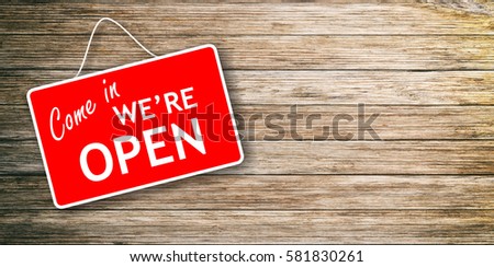 We are open sign hanging on wooden background