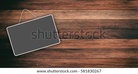 Grey sign hanging on a wooden background