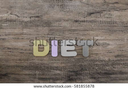 diet word made from colorful letters lie on wooden table background. healthy food sign, symbol, idea