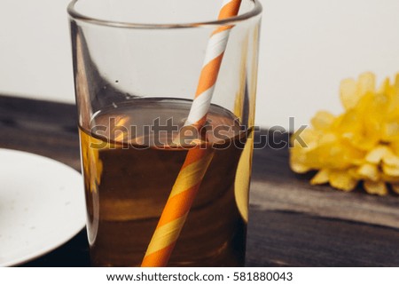 juice in a glass with a straw, yellow flower.