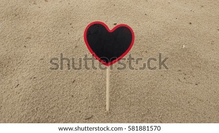 heart shape chalkboard on sandy beach. Composition of Nature.

