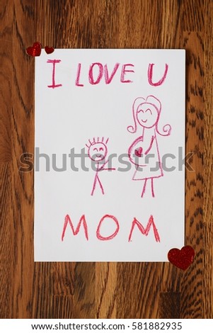 kid draw mothers day card on wood table