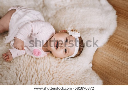 Portrait of a baby lying on a blanket of wool. close-up