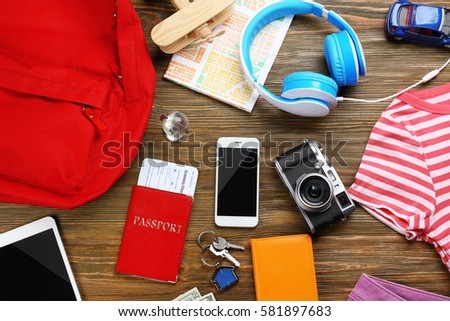 Traveller's outfit on wooden background