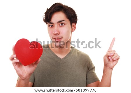 Smiling man with a red heart