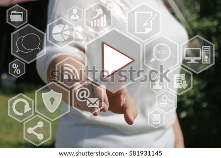 Businesswoman pressing button play  on a touch screen in the global network.