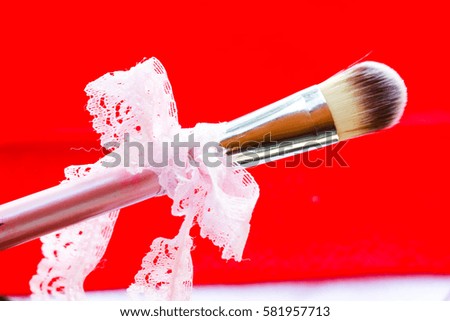 Convert makeup on a red background.