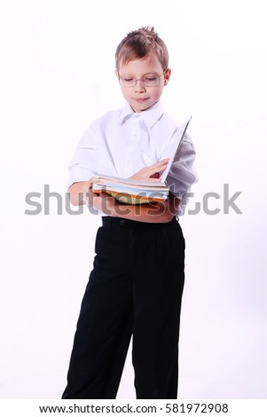 Portrait of caucasian smiling teen boy with notebook and blue pen writing something. Handsome funny teenager, isolated on white background. Happy student making idea gesture.