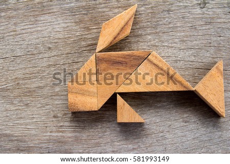 Wooden tangram puzzle in fish shape background