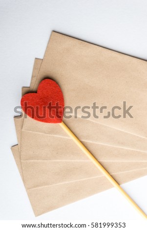 A love stick and brown envelope over white background. Love Concept.