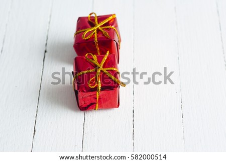two romantic red valentines day gift boxes on white wooden table background