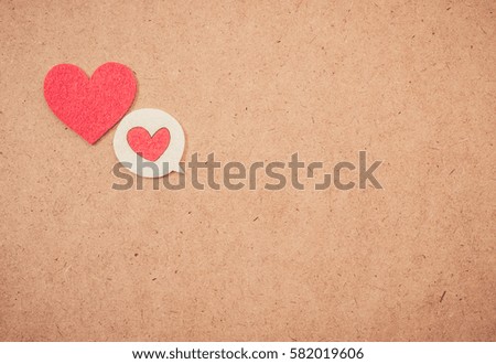 Red heart on brown paper background with copy space. vintage retro color style