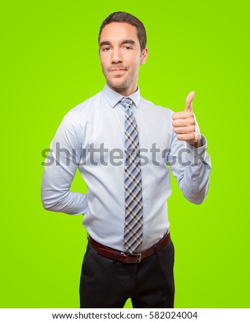 Satisfied young businessman doing an approval gesture