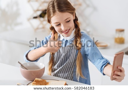 Active young lady making a picture of herself in the morning
