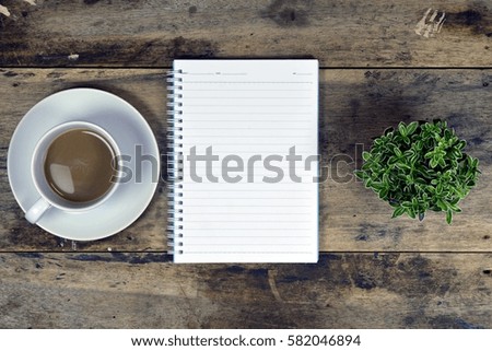 Wood business office desk table with notebook, cup of coffee and supplies on top view business desk with copy space at text of picture. Creative table. Graphic design. Dark tone. Flat lay.