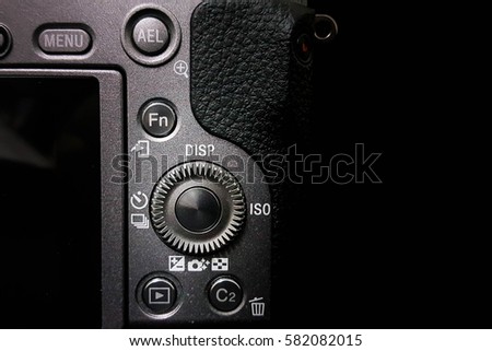 Control dial on a DSLR camera, mirrorless,  close up image isolated on black background