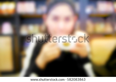 Picture blurred  for background abstract and can be illustration to article of woman drinking coffee in a cafe